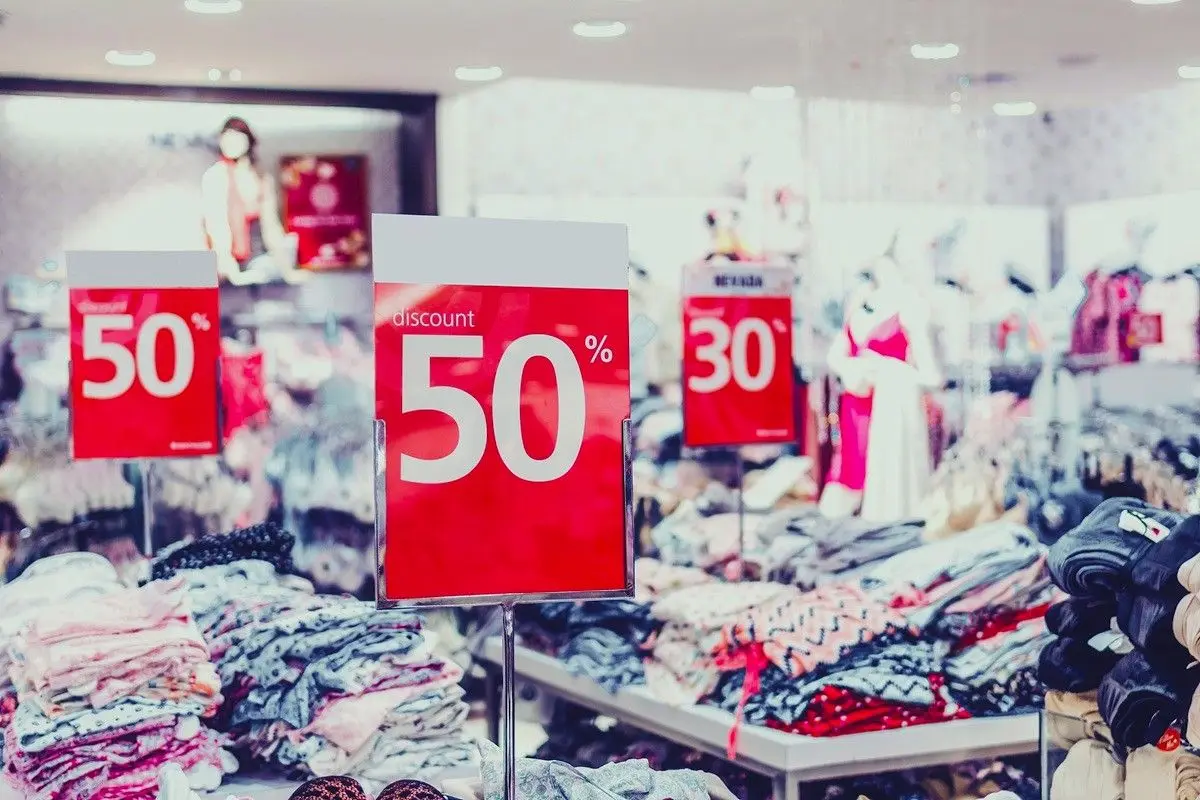 A cloth store with various discount sign including 50% and 30%.