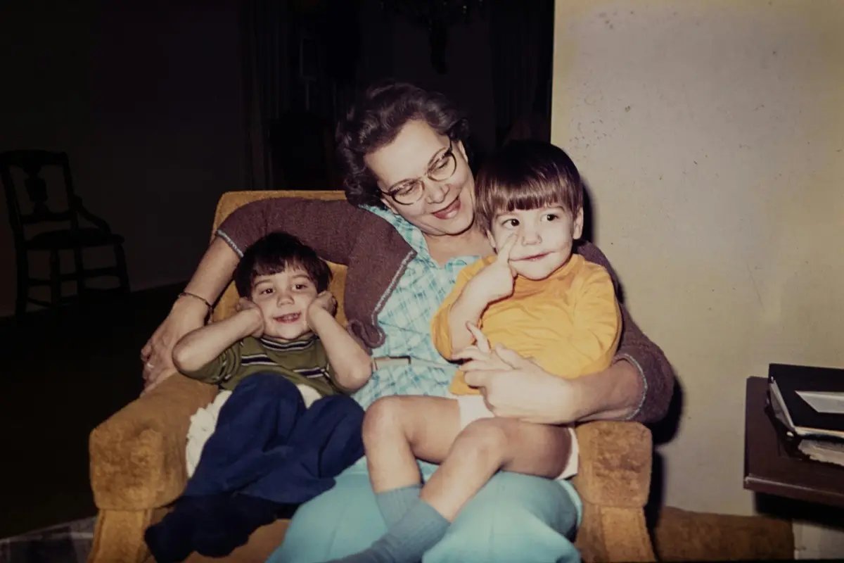 Vintage photo of a aunt lap sitting two of her nephews.