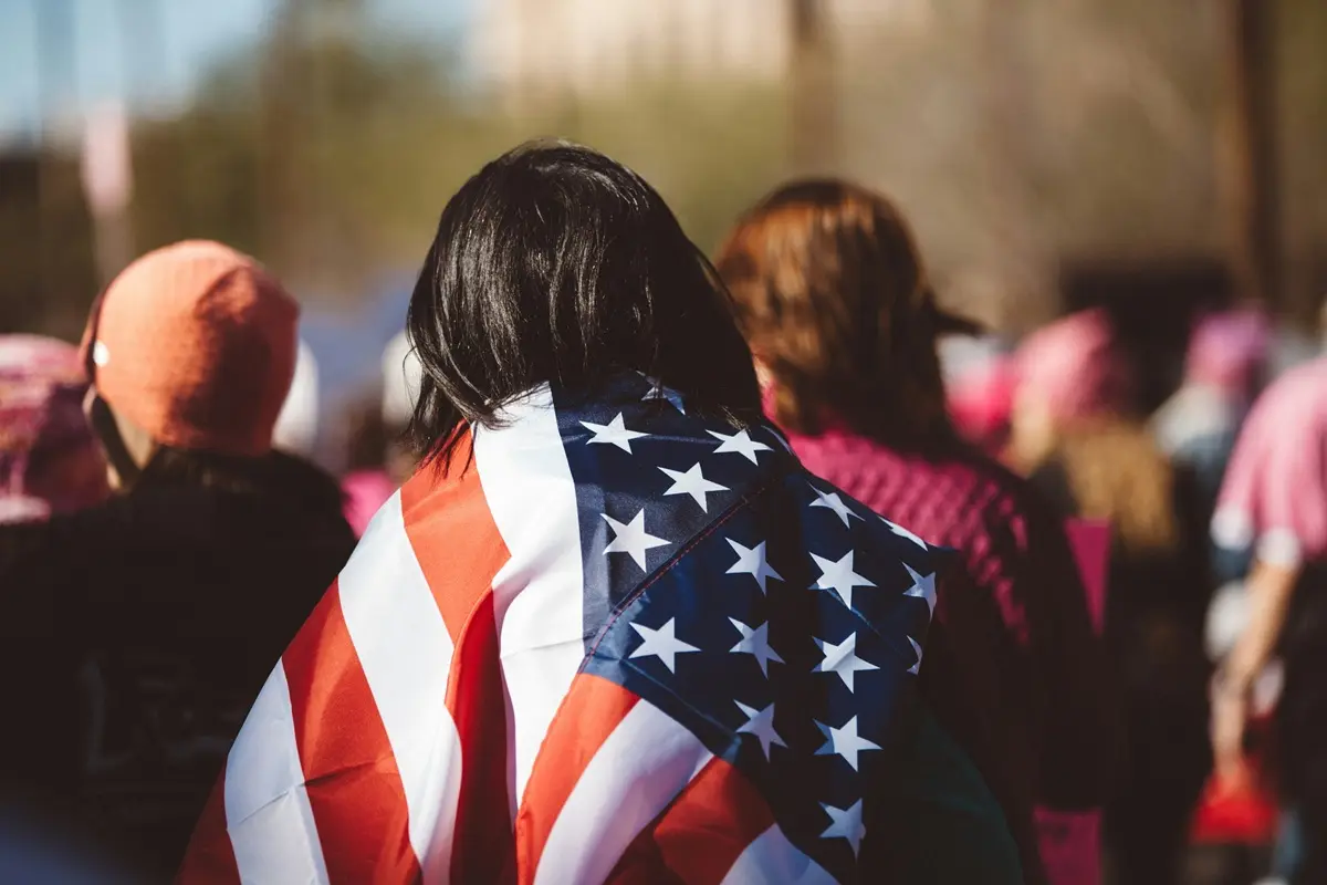 A woman with US American flag on her shoulders.