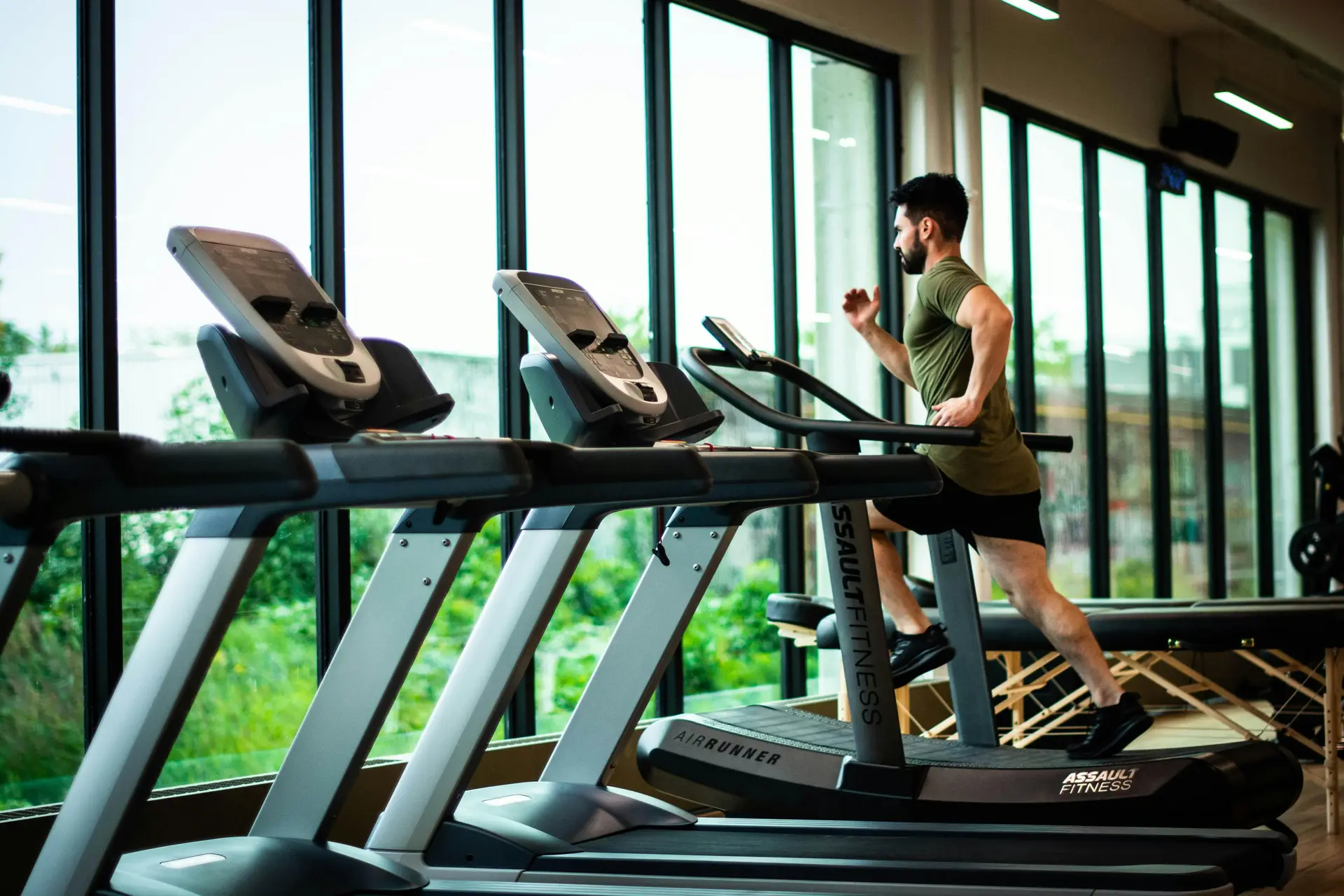 A man Running on a treadmill in a gym.