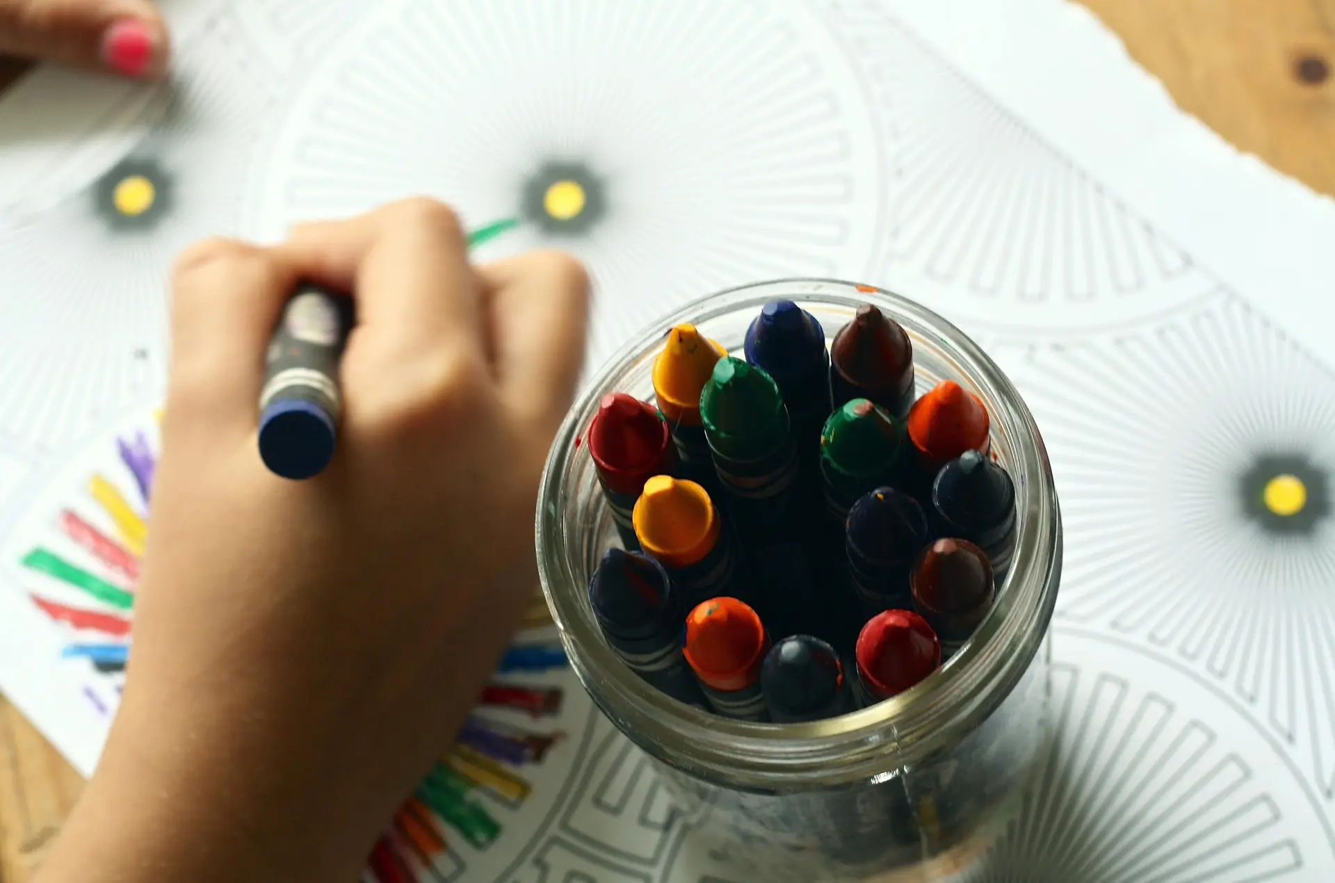 A person drawing with colored pencils.