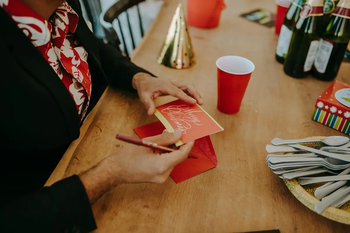 A person writing a christmas card.