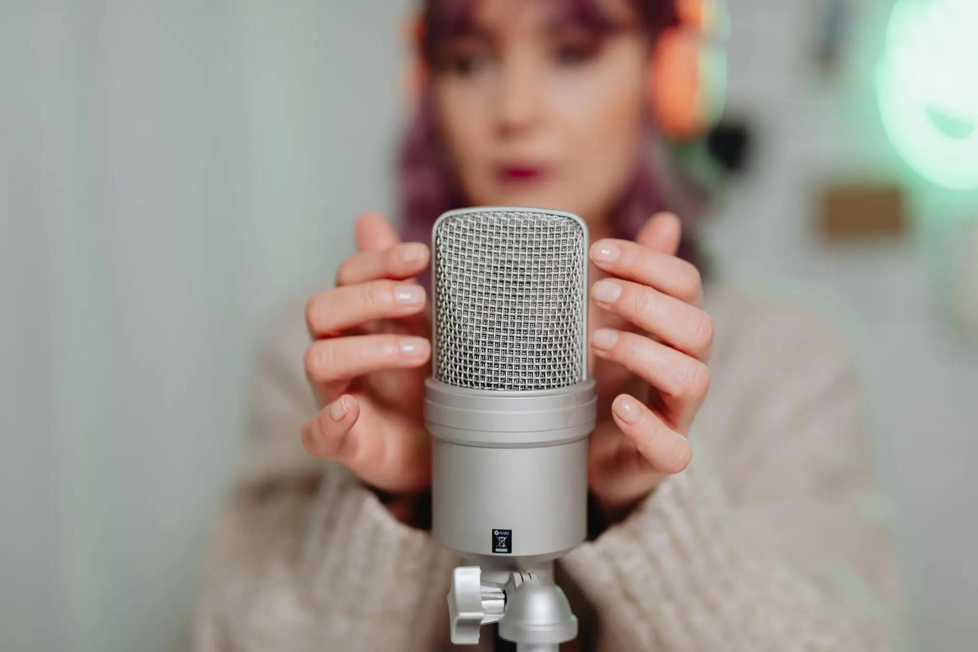 A Woman Touching a Microphone.