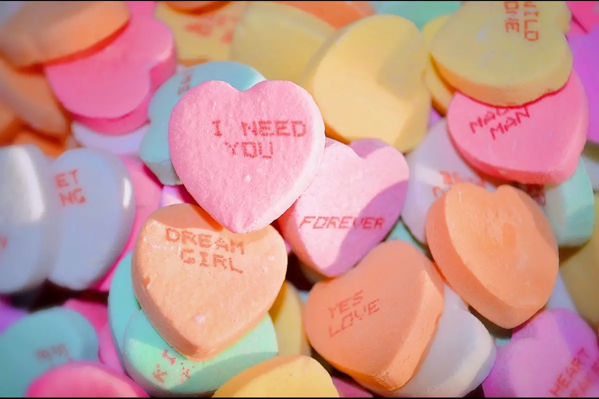 A pile of colorful heart-shaped candies with romantic messages, ideal for Sweetest Day.