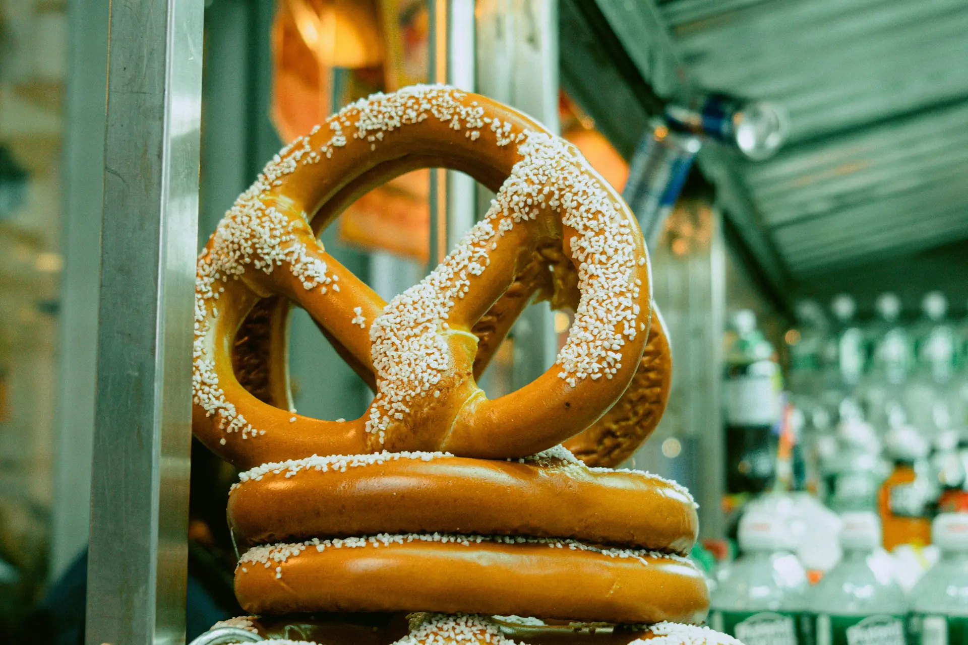 Closeup photo of a pretzel with toppings stacked on two other pretzels.