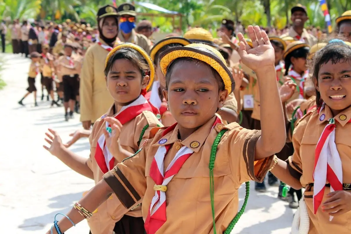 A group of child girl scouts in a parade.