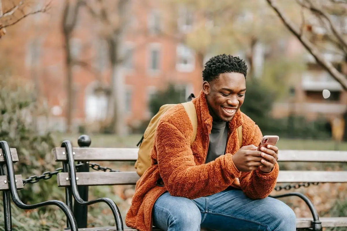 A person checking their phone and laughing.