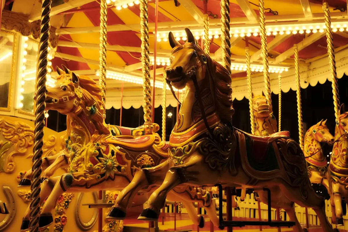 Vibrant carousel horses lit up beautifully on a festive evening.